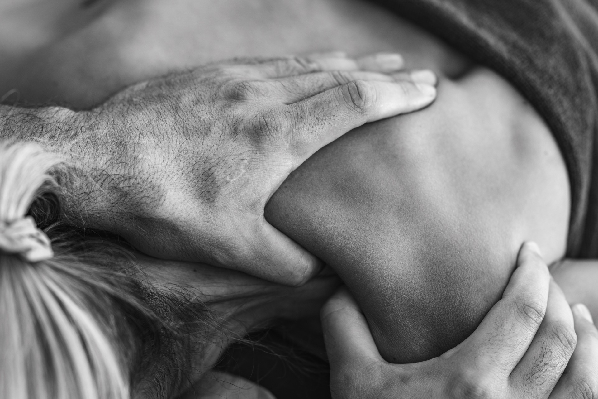 Deep tissue massage by physical therapist on a patients shoulder to relieve muscle tension and improve mobility in a therapeutic setting